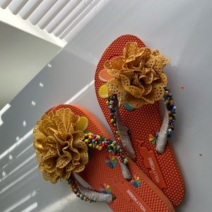 Flip flop with handmade beads and accessories on it